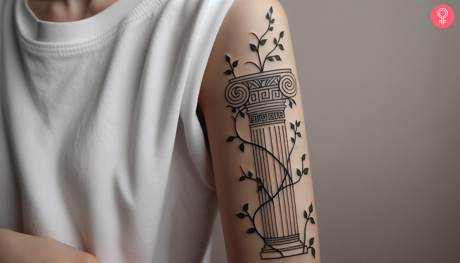 A fineline intricate pillar tattoo surrounded by vines on the upper arm