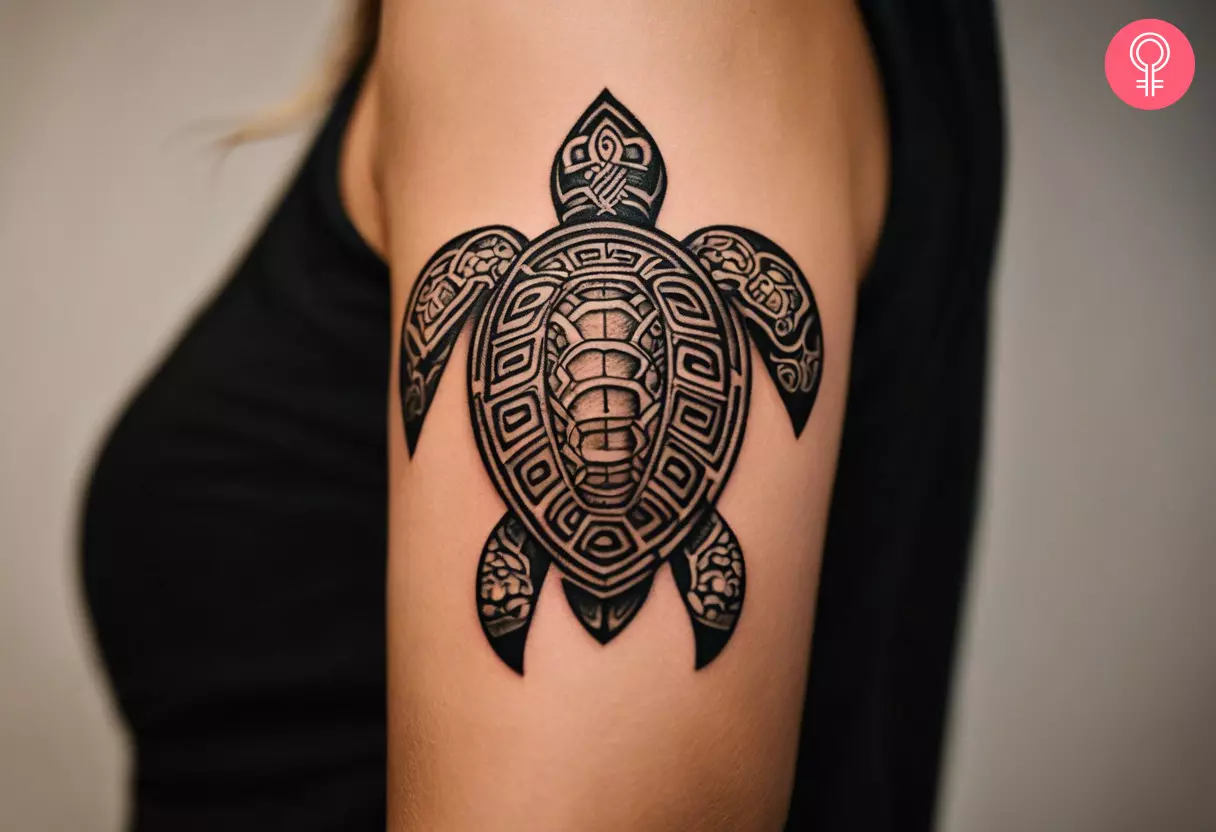 A Hawaiian tribal turtle Mayan tattoo design on a woman’s upper arm