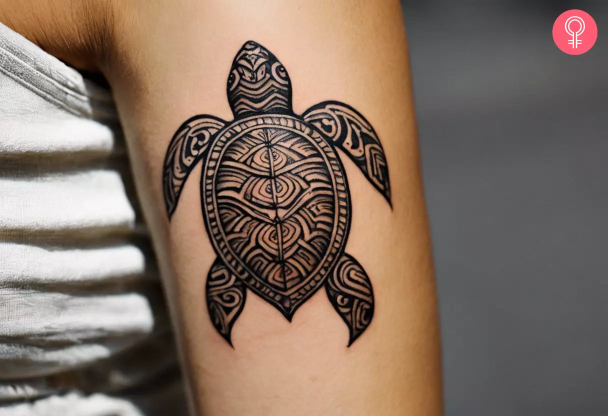 A Hawaiian turtle tattoo on a woman’s upper arm