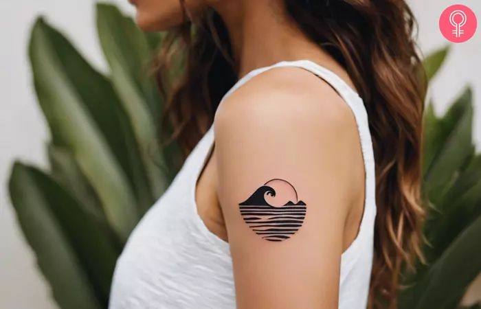 A Hawaiian wave tattoo on a woman’s upper arm