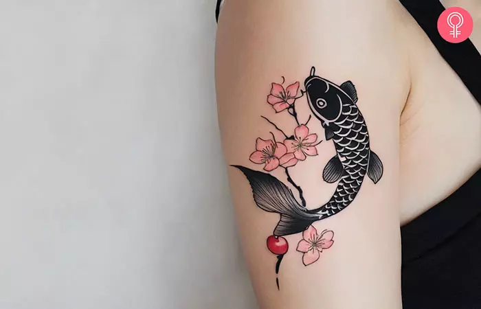 Koi fish and Cherry blossom tattoo on the upper arm