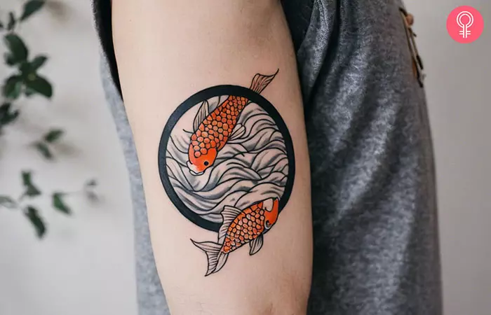 Koi fish circle tattoo on the upper arm