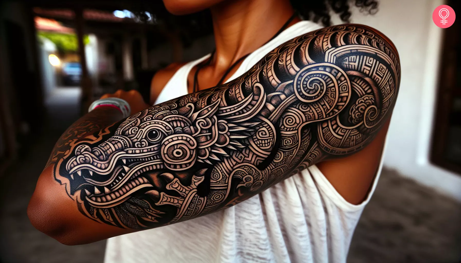A Mayan dragon tattoo on a woman’s arm