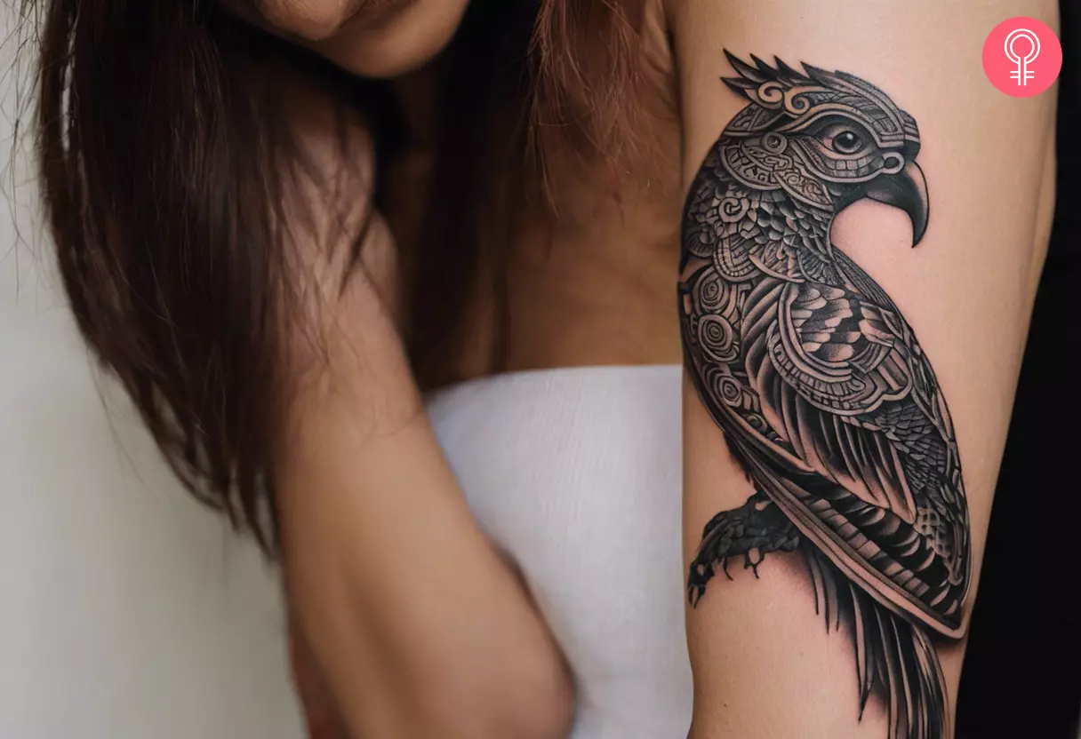 A Mayan quetzal bird tattoo on a woman’s arm