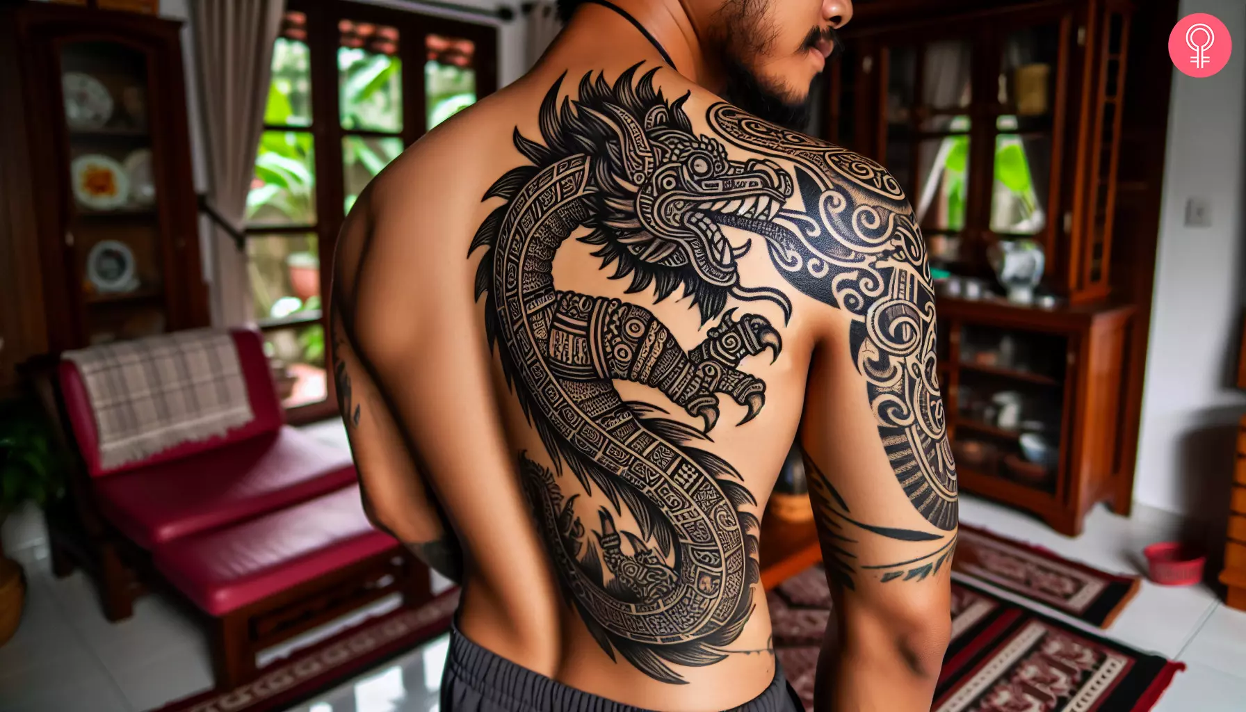 A Mayan serpent tattoo on a man’s back