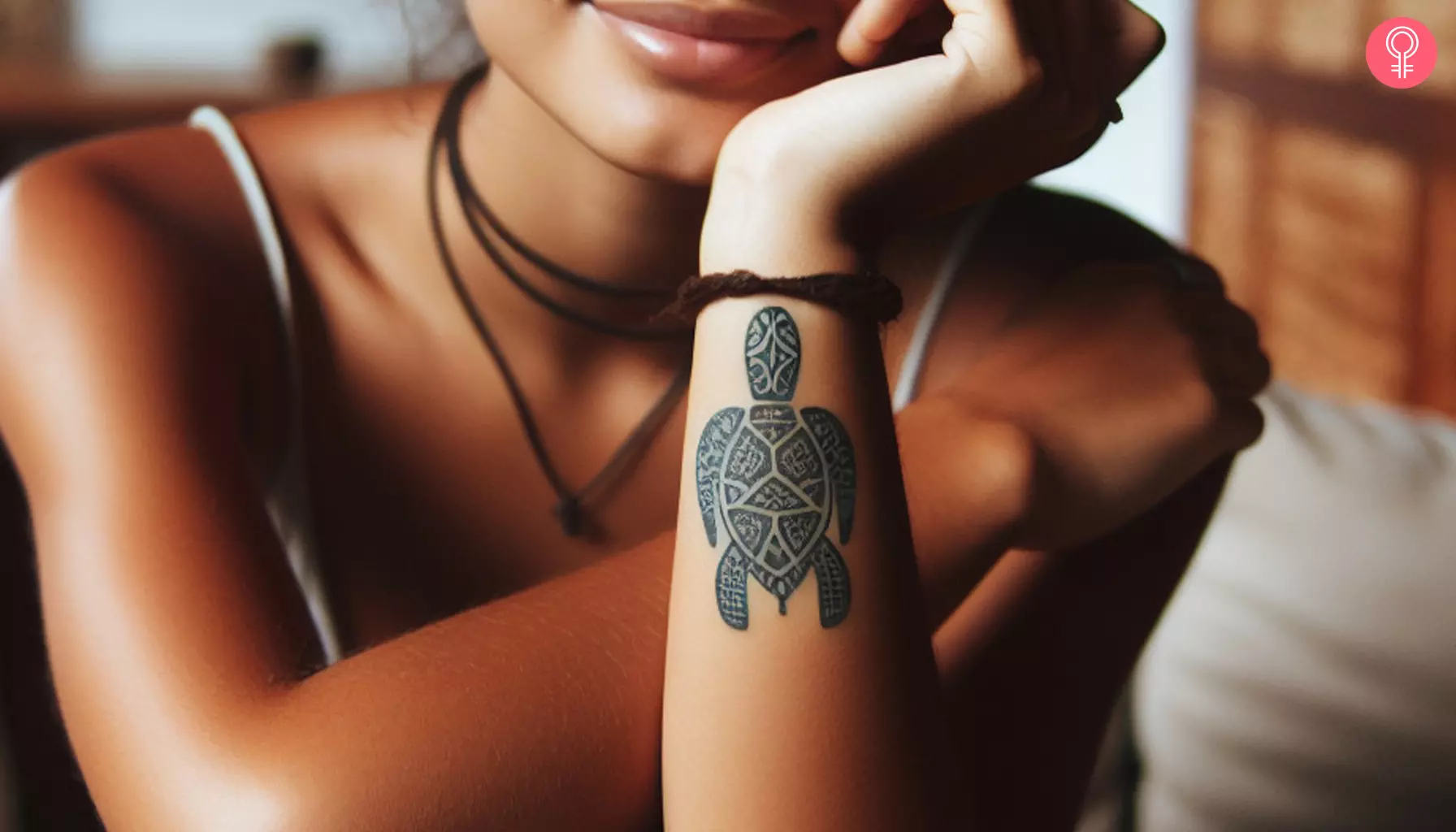 A Mayan turtle symbol tattoo on a woman’s wrist