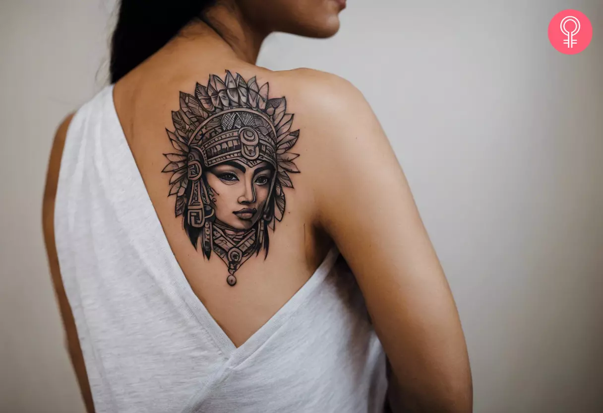 A Mayan warrior tattoo on a woman’s shoulder