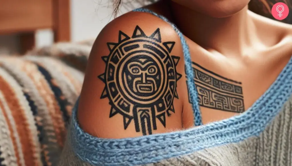 Mayan sun tattoo on a woman’s shoulder