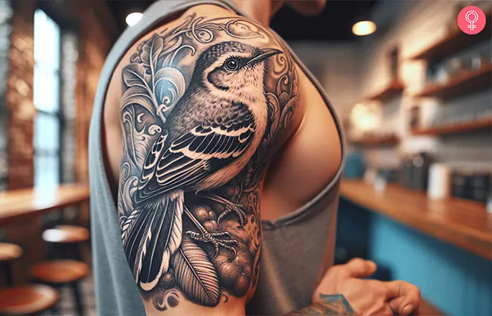 Mockingbird tattoo on the arm of a man