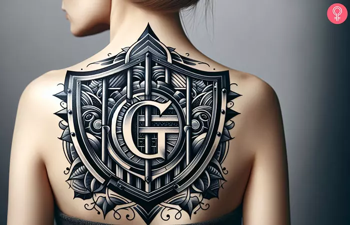 A woman with a prison G shield tattoo on her upper back