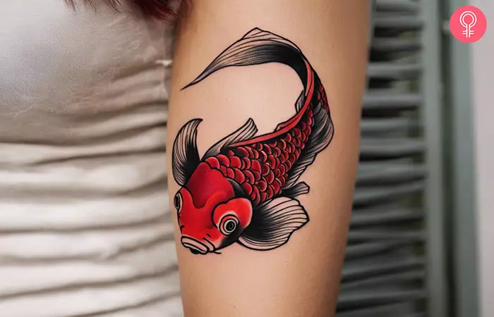 Red and black Koi fish tattoo on the upper arm