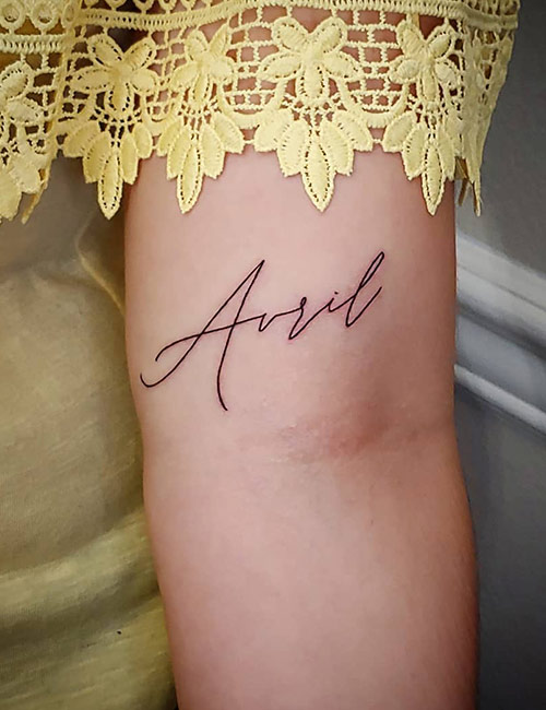 Simple Name Tattoo On Above Elbow