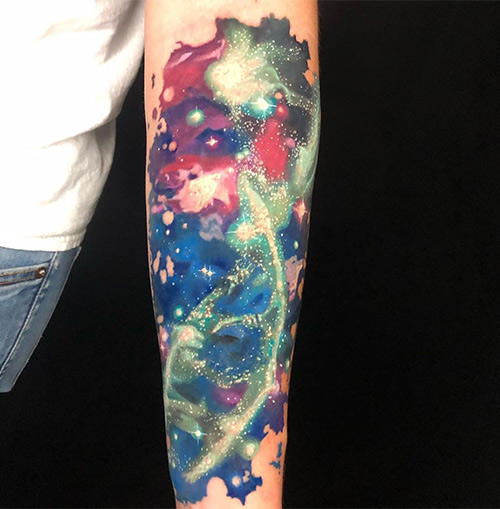 A colorful galaxy tattoo to flaunt on your forearm