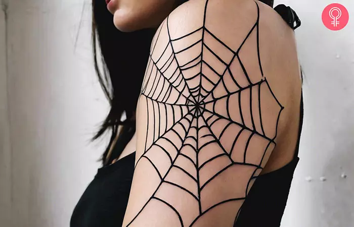 A woman with a spider web prison tattoo on her arm