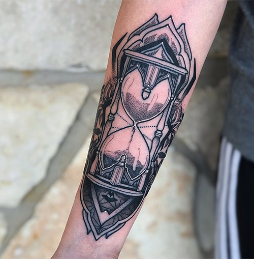Intricate hourglass tattoo design for forearm