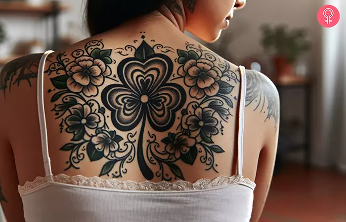 Woman-with-a-shamrock-flower-tattoo-on-her-upper-back