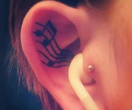 Musical note ear tattoo design