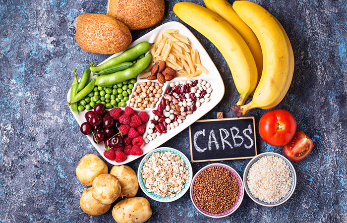 Sources of healthy carbs spread across, included bananas, oats, apples, and peas