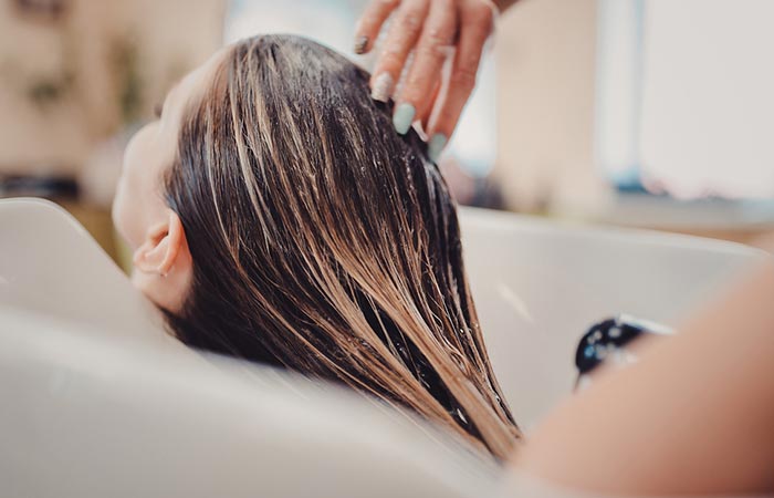 Woman rinsing hair in Listerine