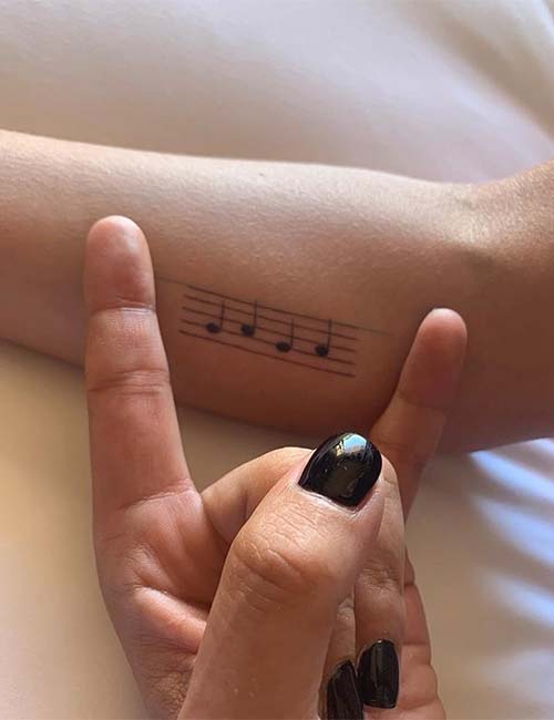 Lady Gaga music notes tattoo