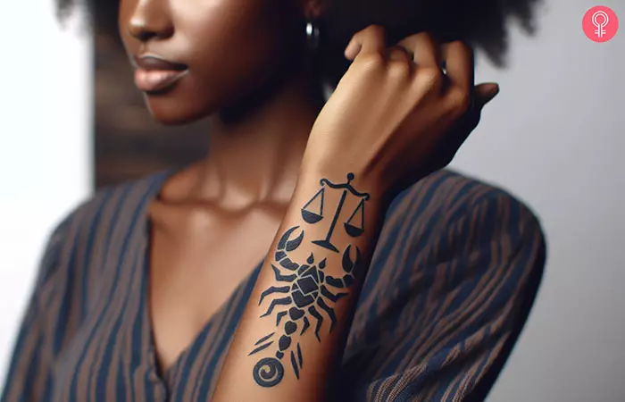 A woman with a Libra and Scorpio tattoo on her forearm