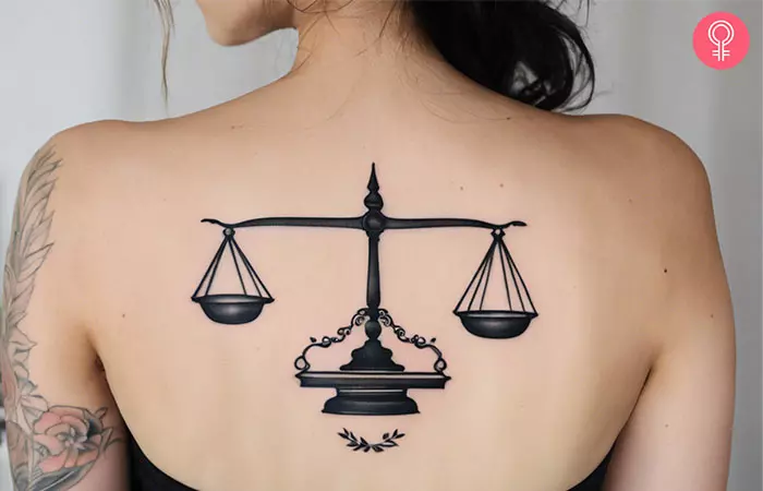 A woman with a Libra spine tattoo