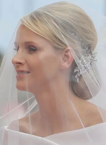 Low bun bride hairstyle with mini bouffant and side sweep