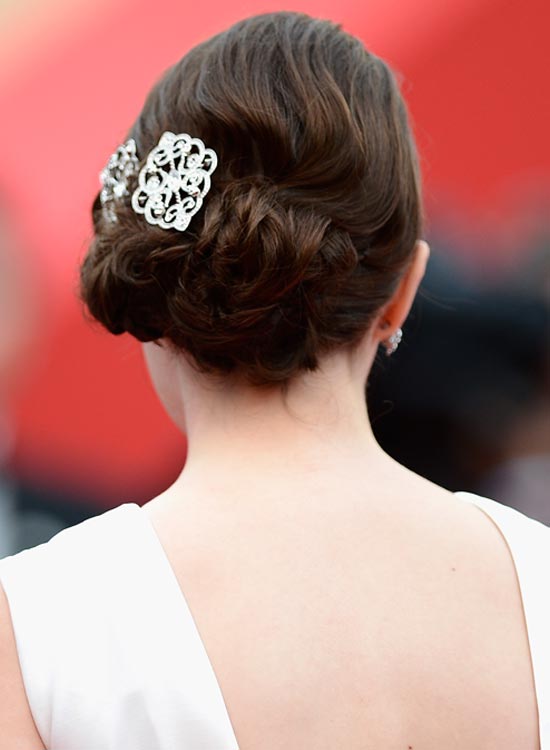 Low flowery with twisted side hairstyle for bride