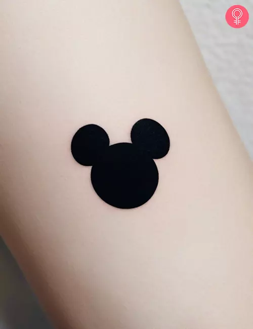 Mickey Mouse silhouette tattoo on the forearm