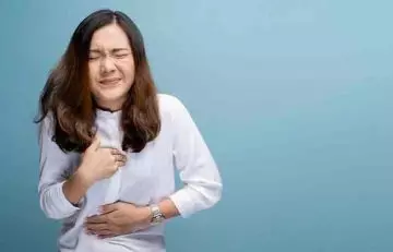 Woman suffering with acidity and heart burn