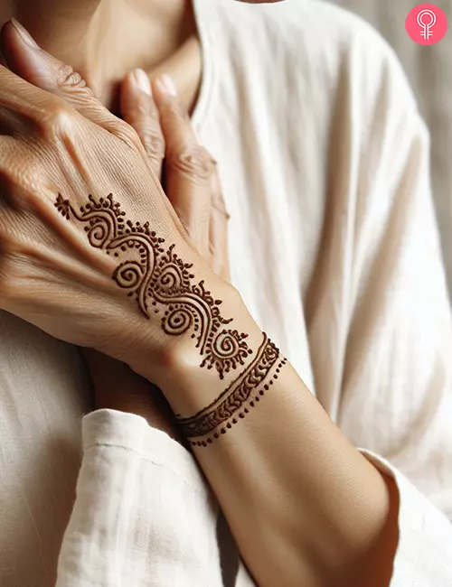 Simple henna tattoo on the hand of a woman