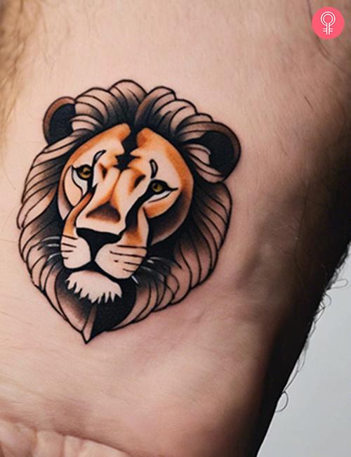 Simple lion tattoo on the wrist of a man