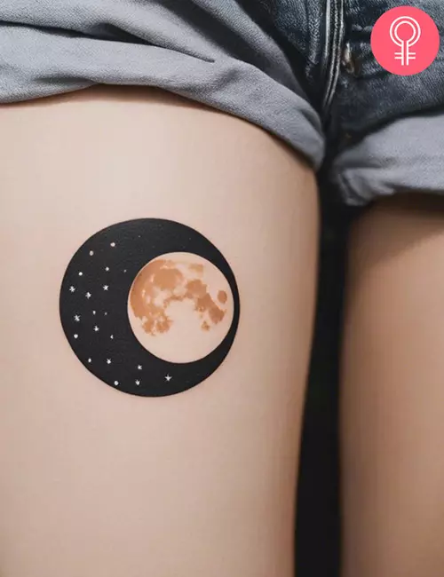 Simple moon tattoo on the thigh of a woman