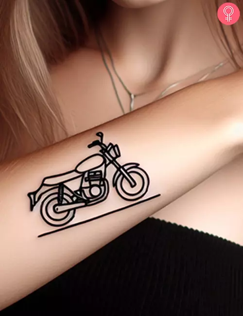 Simple motorcycle tattoo on the lower arm of a woman