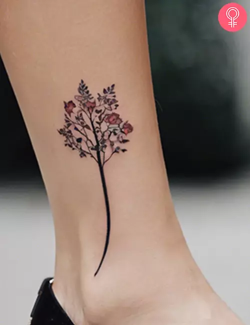 Simple tree tattoo on the leg of a woman