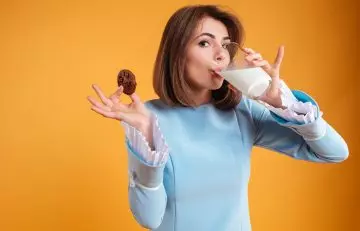 A happy woman drinking milk