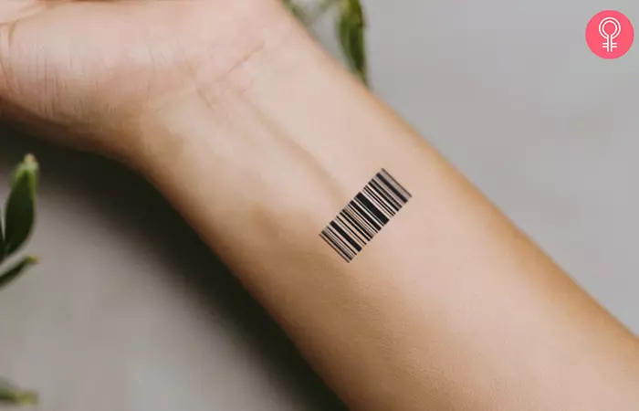 A minimalist barcode tattoo on the wrist