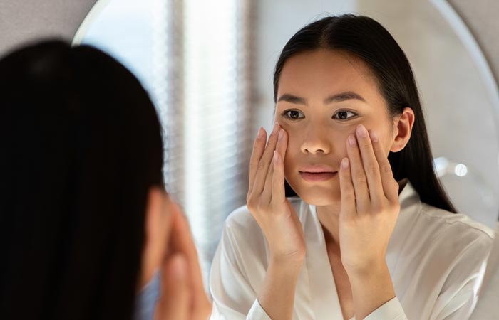 Women treating her skin to keep acne and breakouts at bay