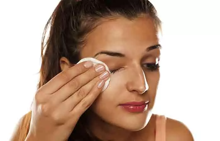 Woman removes her eye makeup