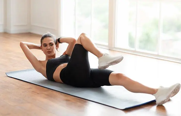 Woman performing bicycle crunch