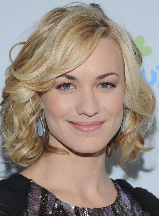 Short blonde curly bob with side swept bang hairstyle