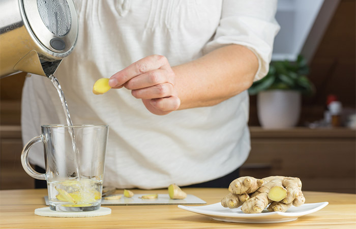 Woman preparing ginger water at home for diarrhea 