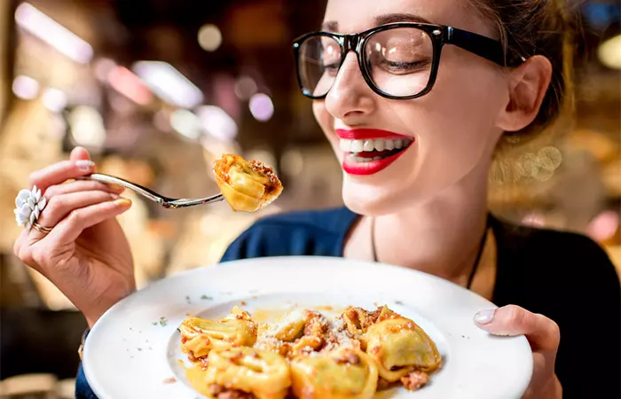 Woman having pasta to reduce uric acid