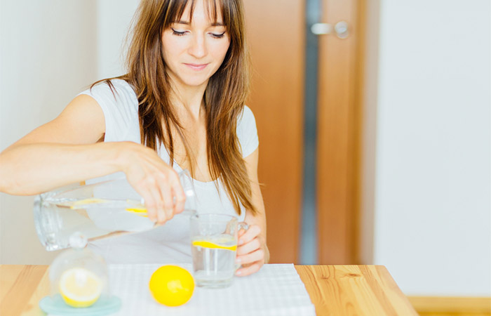 Woman having lemon water to treat diarrhea 