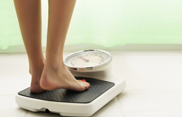 Close up of woman measuring her weight