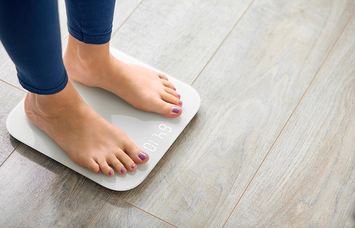 Closeup of a woman's feet on a digital weighing machine