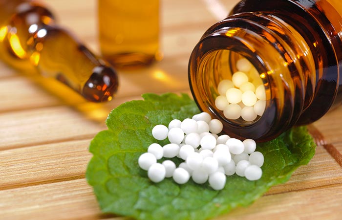 Globules of homeopathic medicine on a leaf
