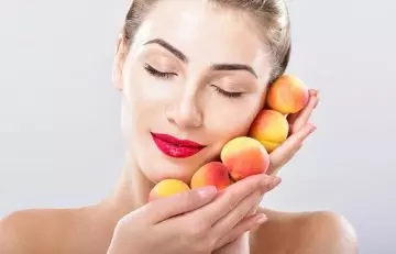 Woman holding peaches