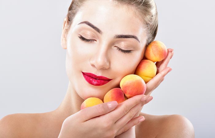 Woman holding peaches