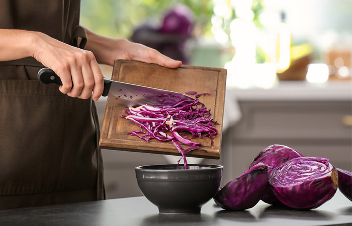 Woman making red cabbage salad 
